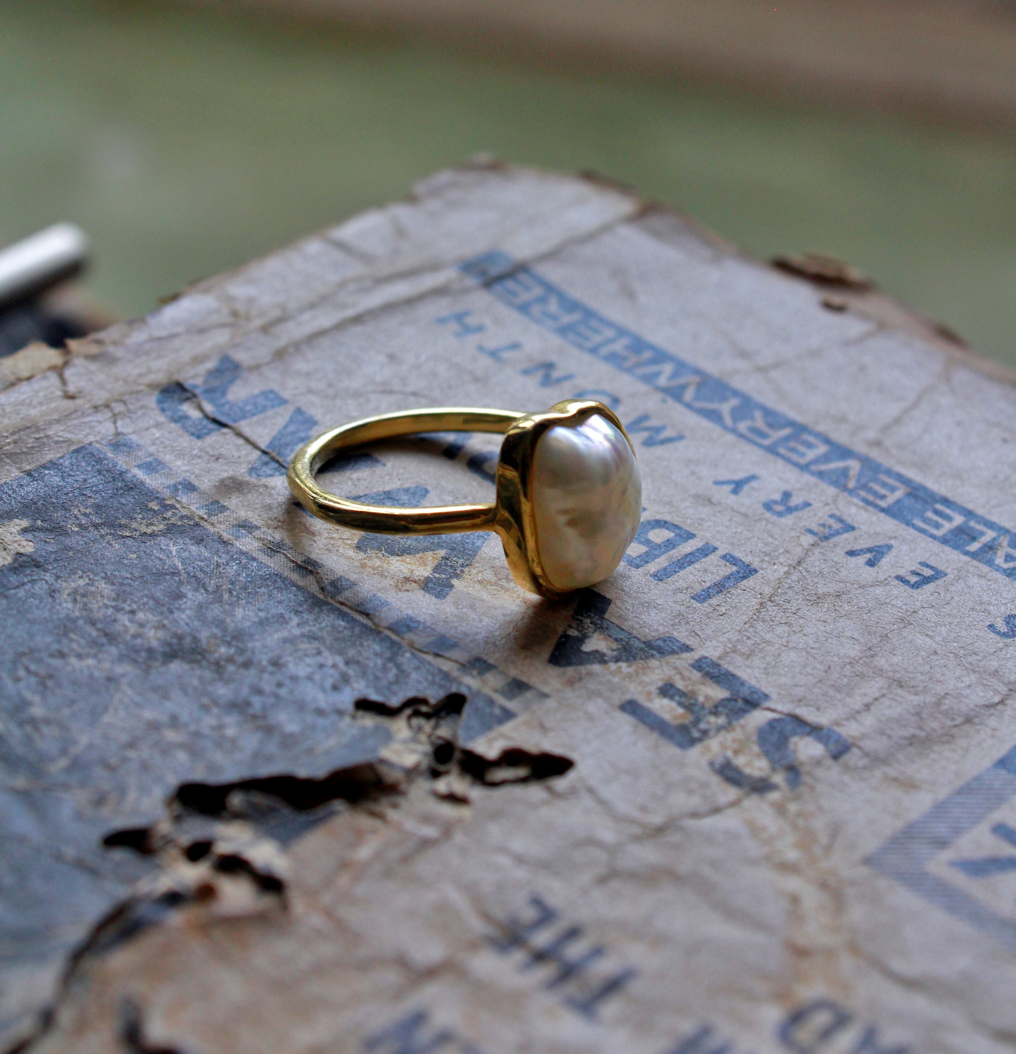 single natural freshwater pearl ring on old book